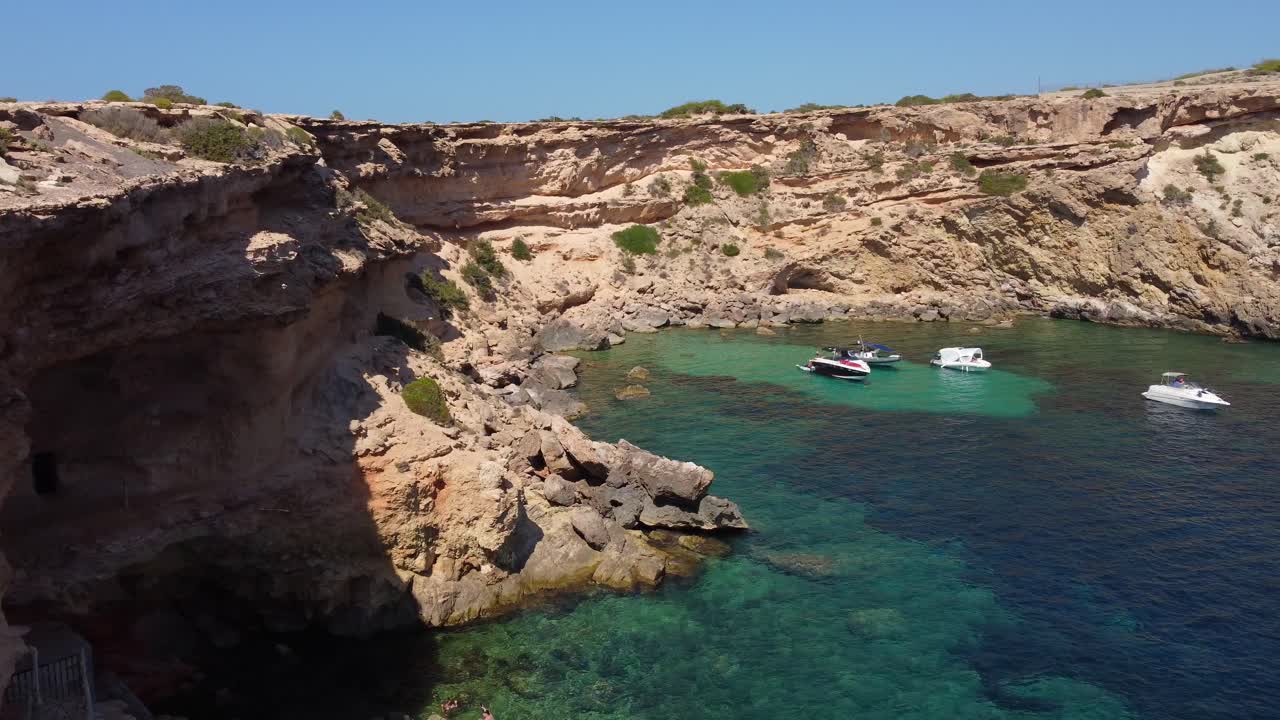 las calas más bonitas para nadar, relajarse en ibiza vista aérea atrevida panorama vuelo curvo imágenes de drones de la playa del borde del acantilado sa figuera borda verano 2022 4k cinematográfico desde arriba por philipp marnitz
