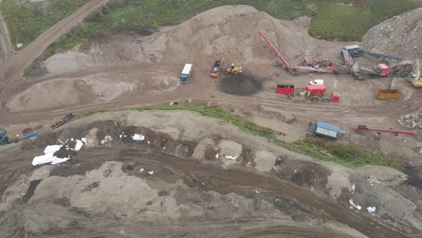 Aerial-of-excavator-dumping-sand-in-truck---wide