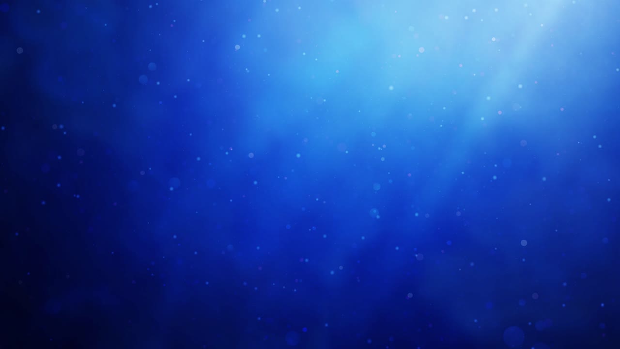 Blue light rays in billowing smoke or fog with floating bokeh particles