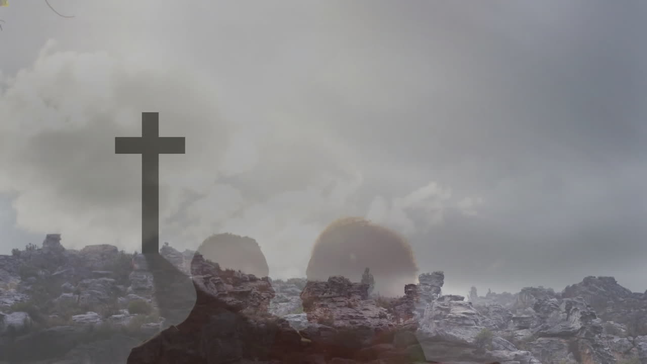 Silhouette of person with cross in animation over rocky landscape and cloudy sky