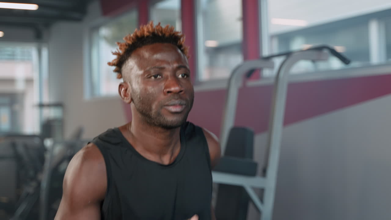 Man Exercising on Treadmill in Gym