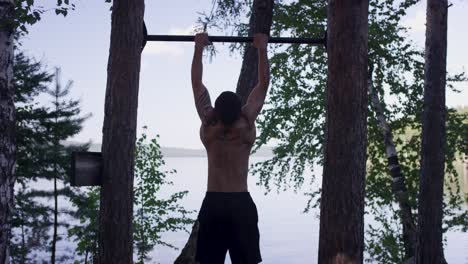 man doing pull-ups outdoors