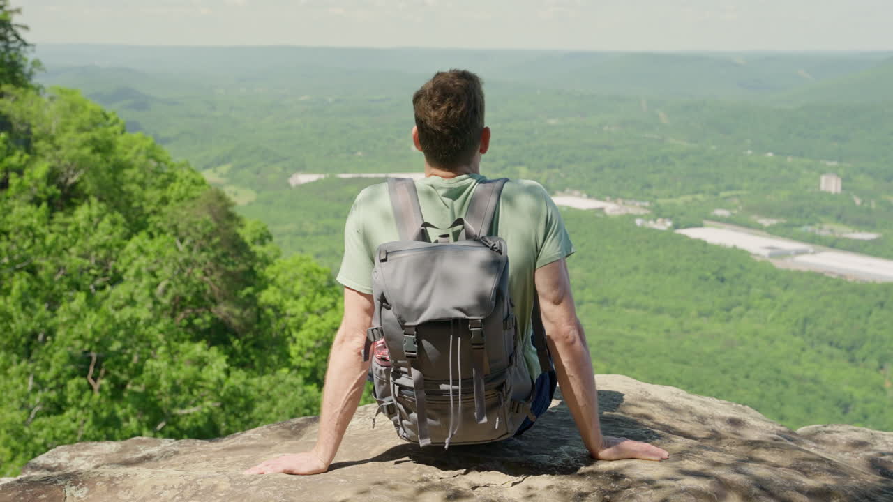 A hiker lookin at the view of a mountain top after hiking a trail. beautiful nature of north America. Rugged cliffs, lush valleys, or winding trails stretching out exploration, freedom.