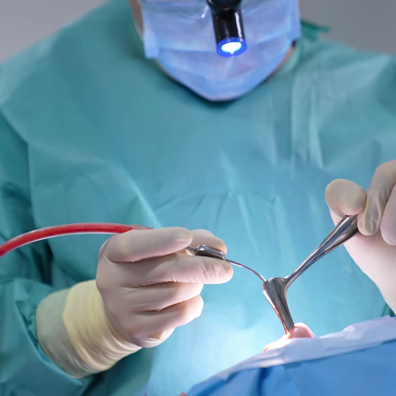 Surgical instruments in doctor's hands. Doctor performs surgical procedure using special medical tools. Nurse assists doctor during operation. Close-up