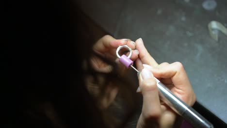 jeweler polishing a ring