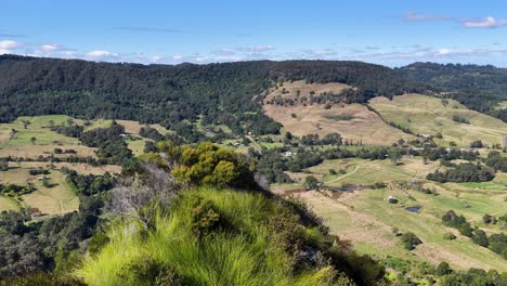 panoramic view of lush landscapes and rocky outcrops under clear skies in nimbin, nsw, australia