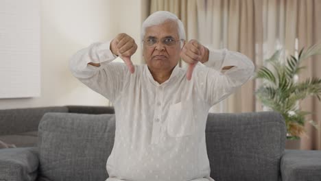 Angry-Indian-old-man-showing-thumbs-down