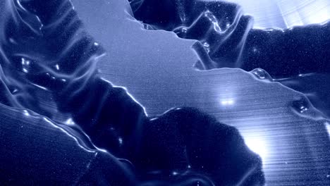 stylish festive black bg. fantastical abstract looped background, waves move on glossy surface like landscape made of liquid blue wax with sparkles. beautiful soft background with smooth animation 4k