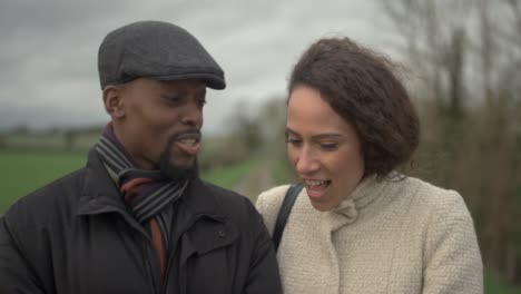 couple walking through countryside cu