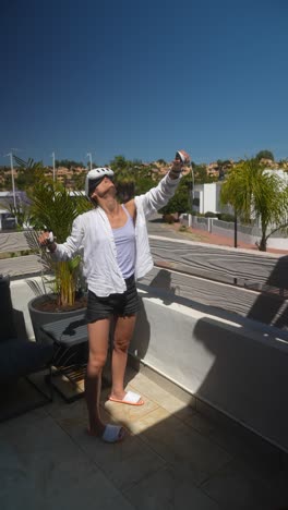 woman enjoying vr experience on a sunny balcony