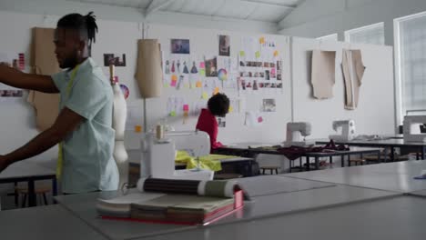 Mixed-race-man-working-in-fashion-office