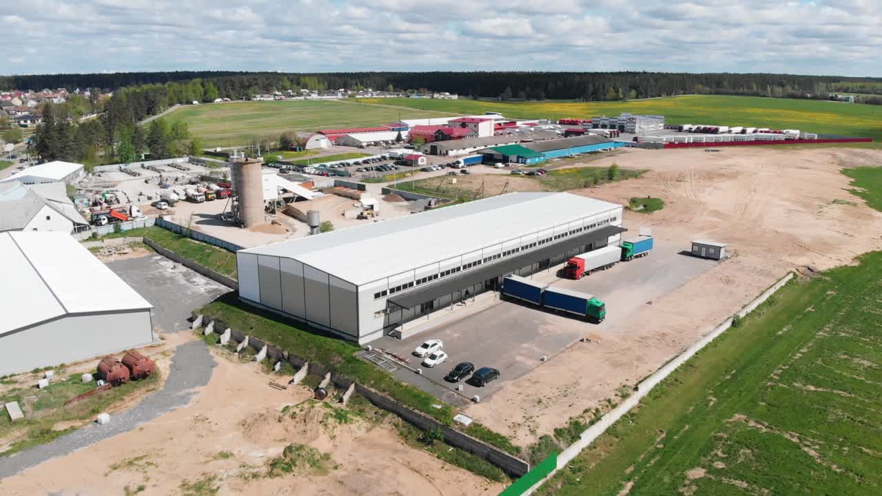 Top view of the logistics center - warehouse, trucks.