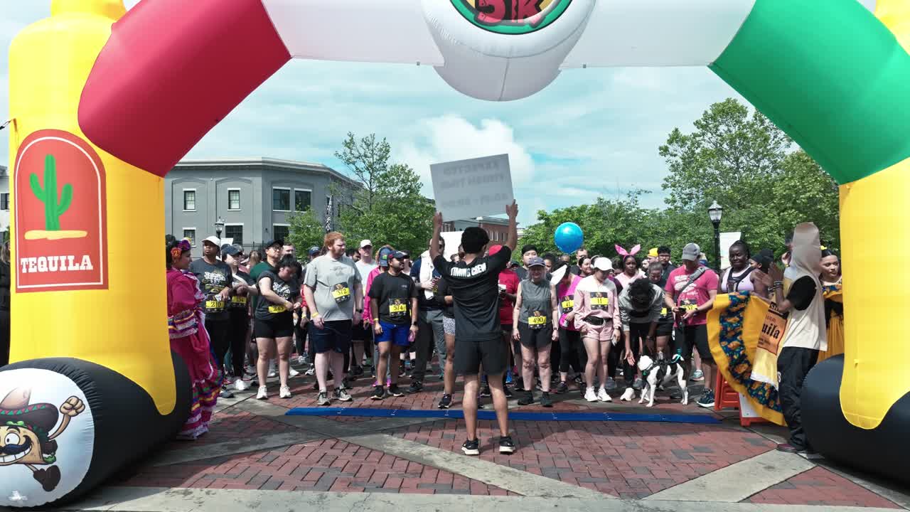 Participants Ready To Run At Starting Line Of Tacos And Tequila 5K Race In Suwanee, Georgia. wide shot