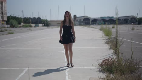 woman walking in empty urban lot