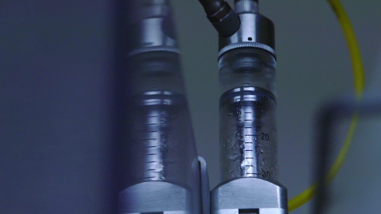 Liquid filled syringe in lab context reflects global health and crisis safety