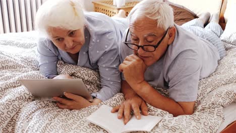 senior couple using digital tablet