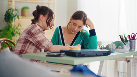 Mother-Explains-Her-Daughter's-Homework-While-Studying-for-School