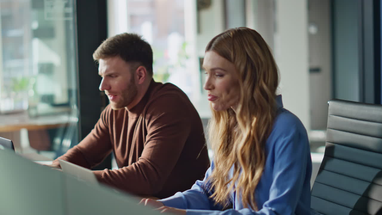 Man woman working office having friendly conversation closeup. Employees typing