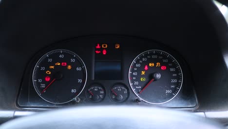 close up view of the car lights on the dashboard lighting up and flashing as car is started in harare, zimbabwe.
