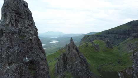 advance drone shot between old man of storr rock formations in isle of skye scotland