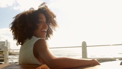 Woman-standing-with-arms-crossed-near-sea-4k