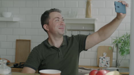 man taking a selfie in his kitchen