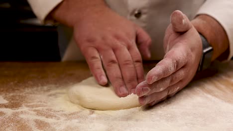 chef kneading dough