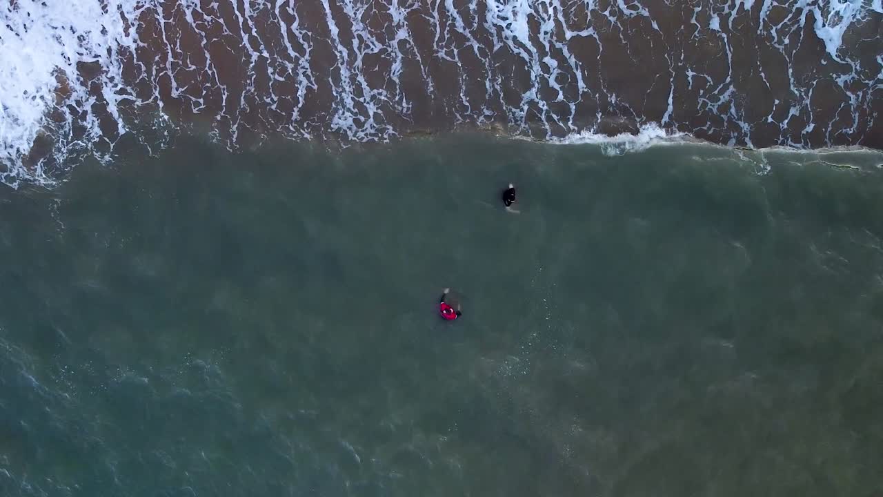Aerial Top Down View Of Two People Wading In Waters At Trinity Beach