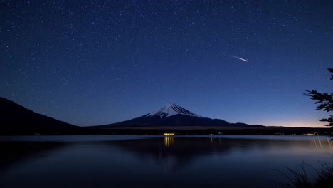 stunning night view of mount fuji with a comet reflected in lake