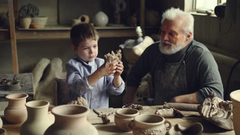 grandfather and grandson making pottery