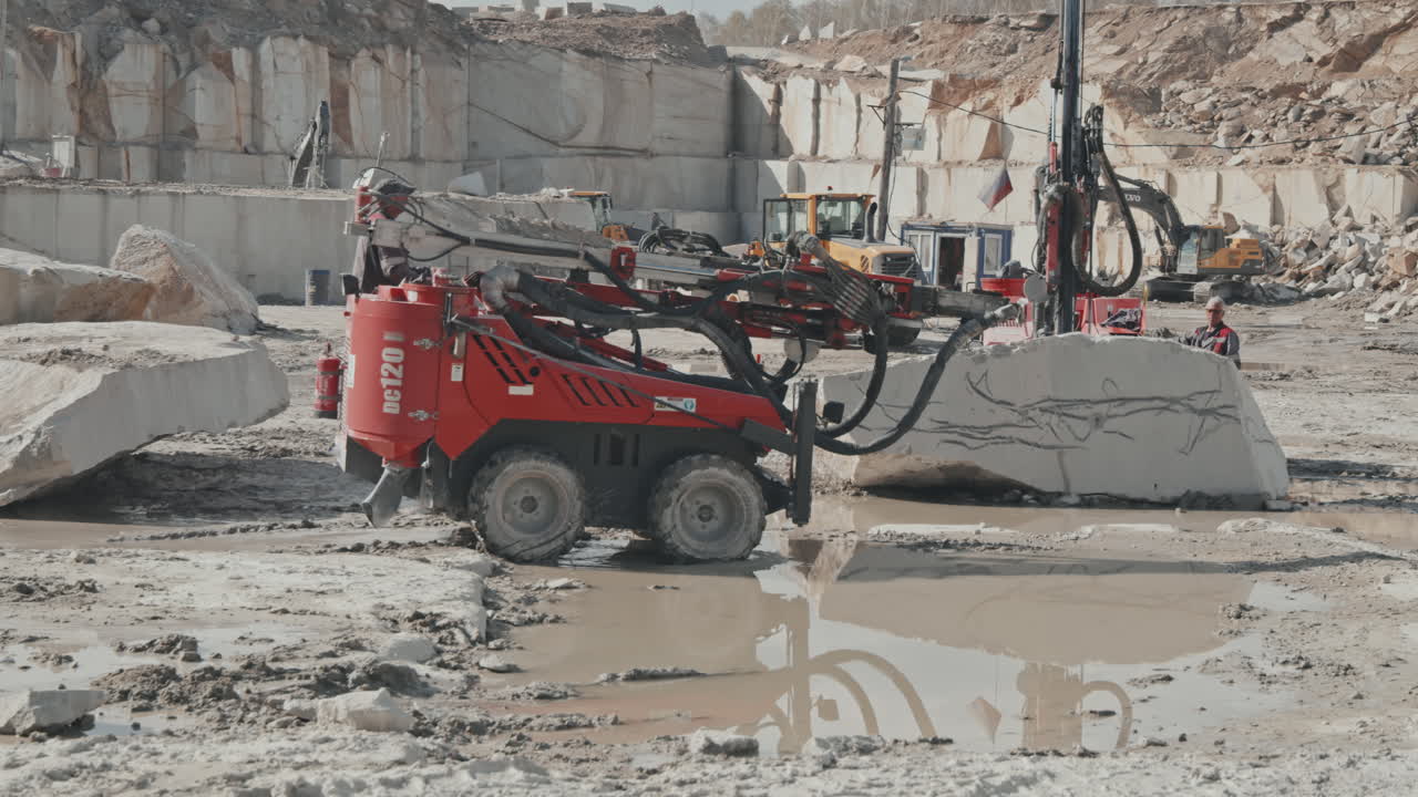 Worker Driving Drill Rig Machine in Quarry