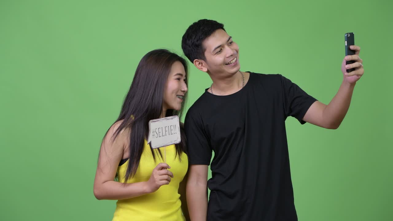 Young happy Asian couple taking selfie together | Premium Stock Video ...