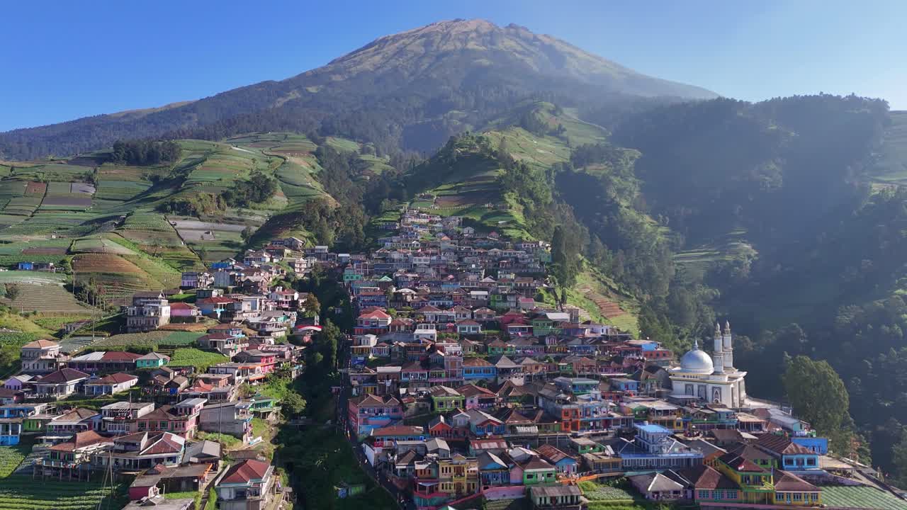 Aerial scenery of remote mountain village with farmland carved into the slopes. Serene and vibrant rural community set against a majestic mountainous backdrop. Nepal Van Java, Indonesia