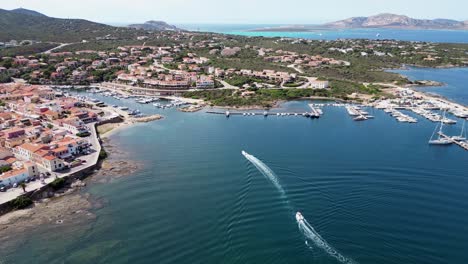 boats sailing towards stintino port in sardinia, italy - 4k aerial