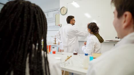 chemistry class with students and teacher in lab