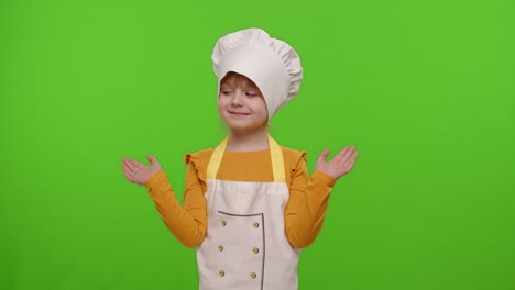 a young girl dressed as a chef smiling and looking at the camera