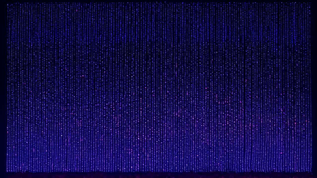 Playing frames showing patterned light panel shifting purple to amber tones at stage, LED curtain