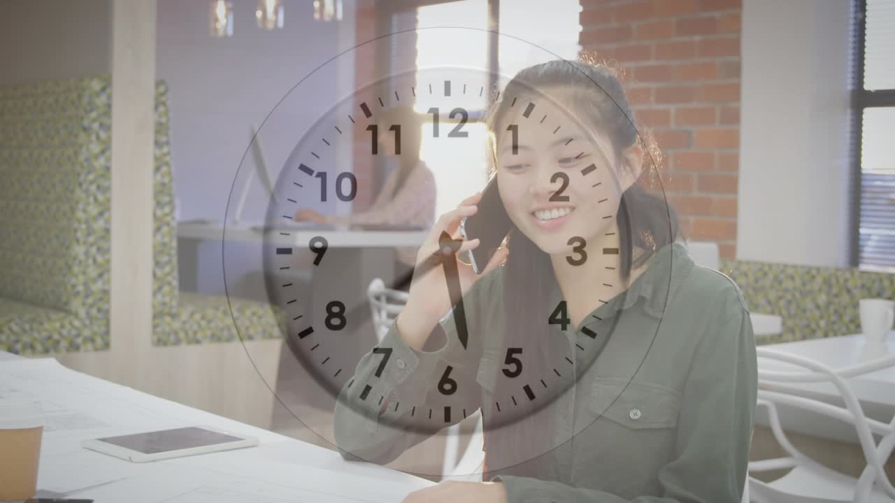 Woman tapping smartphone to initiate business call, laughing and jotting notes amid clock overlay