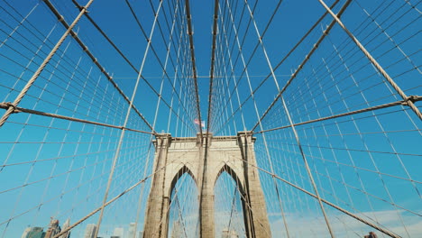 Walk-On-The-Brooklyn-Bridge-Pylons-And-Ropes-Of-The-Bridge-Against-The-Serene-Blue-Sky