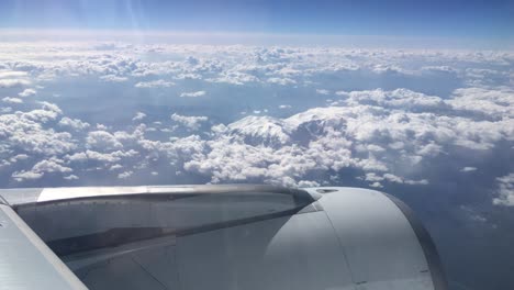 turbine view from an airplane flying above the clouds and the snowed mountains of alps in europe 2