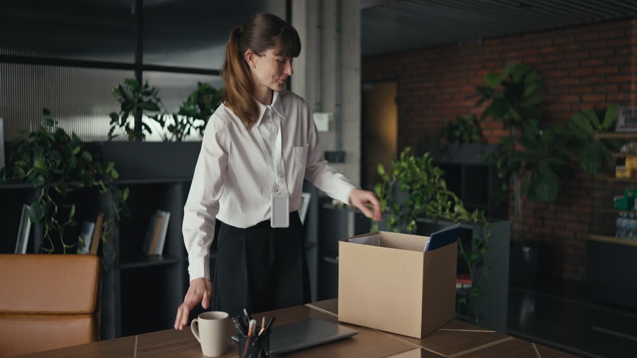 Woman Packing Belongings in Office