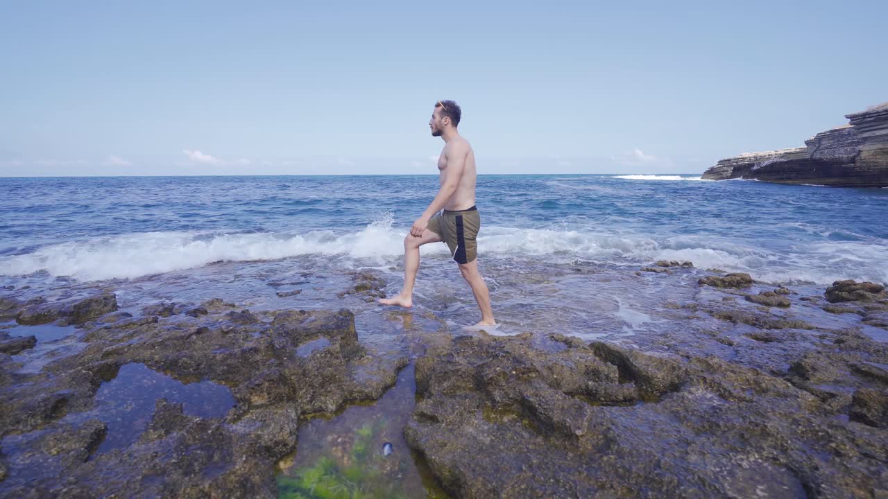 un joven caminando en el mar.