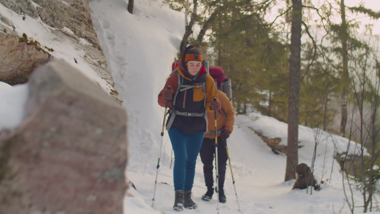 Couple Hiking in Mountains on Winter Day