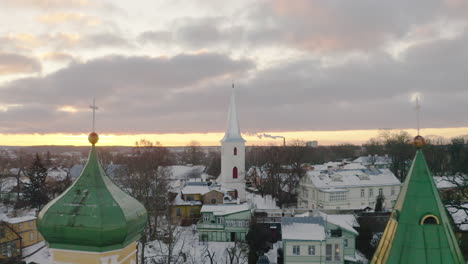 orthodox and a lutheran church in winter dusk light