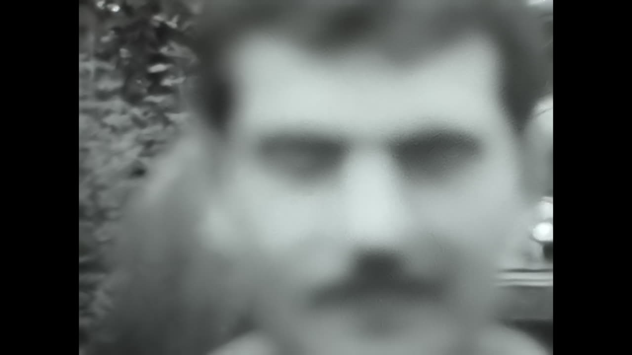 Man Kneeling Next to Woman in Field - Soviet Union Archive Photo. CIRCA USSR 1980s: A man in the Soviet Union kneels down next to a woman in a field, captured in this archival photo.