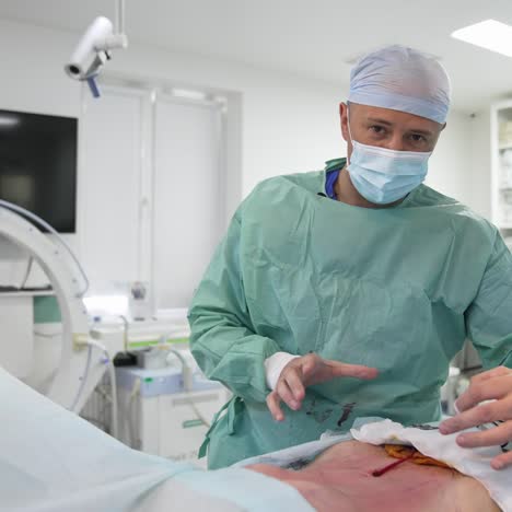 Doctor finishes the operation on a patient. Plastic surgeon talking about liposuction process showing on patient. Surgery for pumping fat for body rejuvenation
