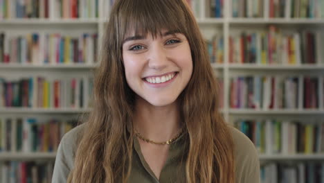close up portrait of young pretty librarian woman smiling happy looking at camera in library bookshelf background