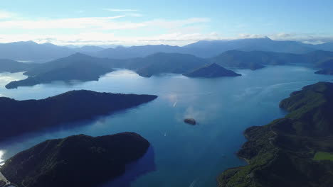 Aerial-drone-shot-of-seawater-and-islands-with-some-boats