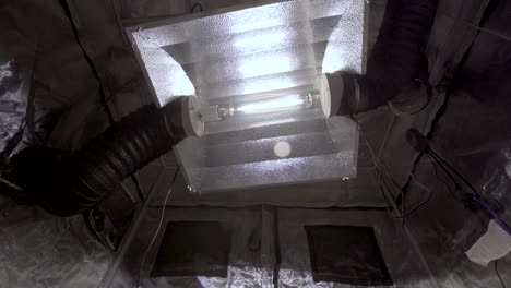 metal halide lamp with lights on inside a cabin - low angle, zoom-in