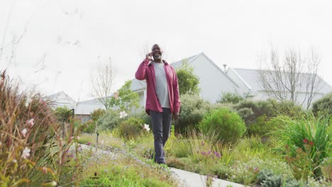 video of happy african american men walking in the garden